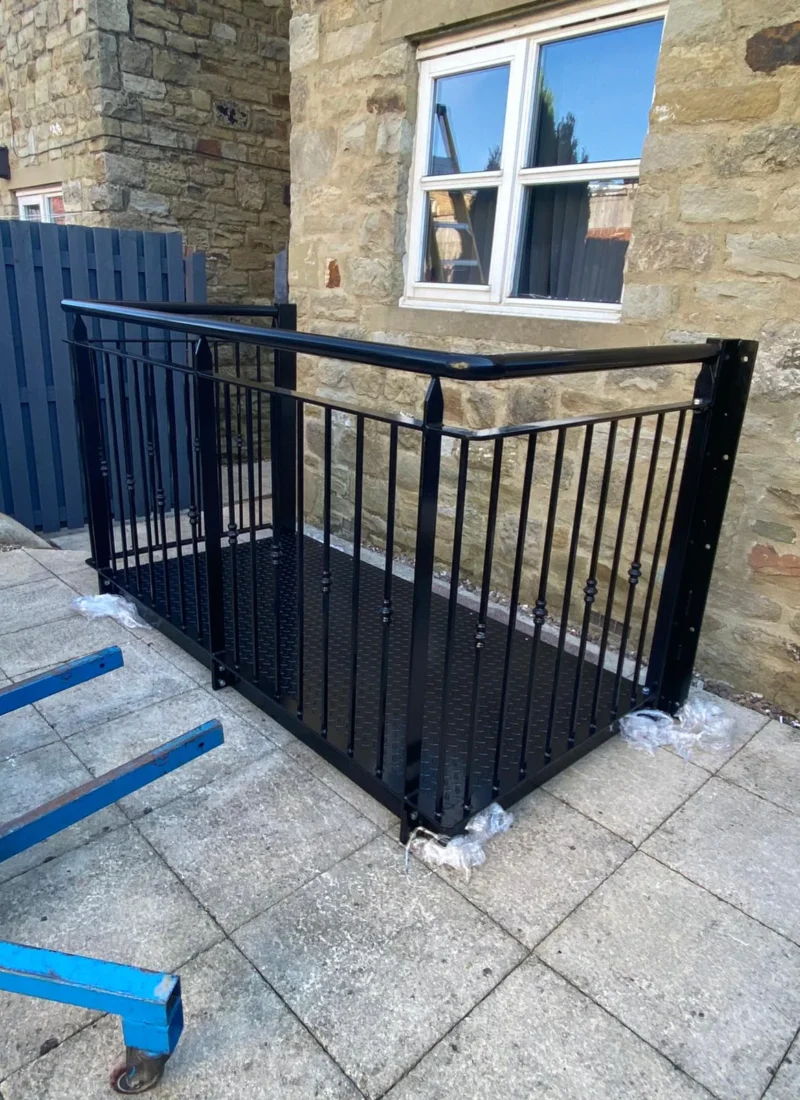 Black steel balustrade to a raised patio area