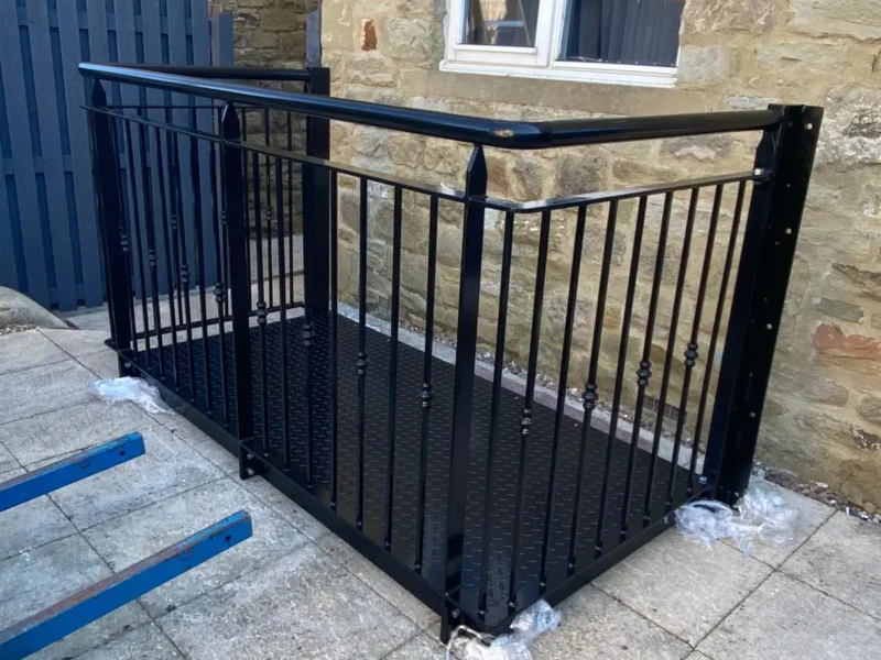 Black steel balustrade to a raised patio area