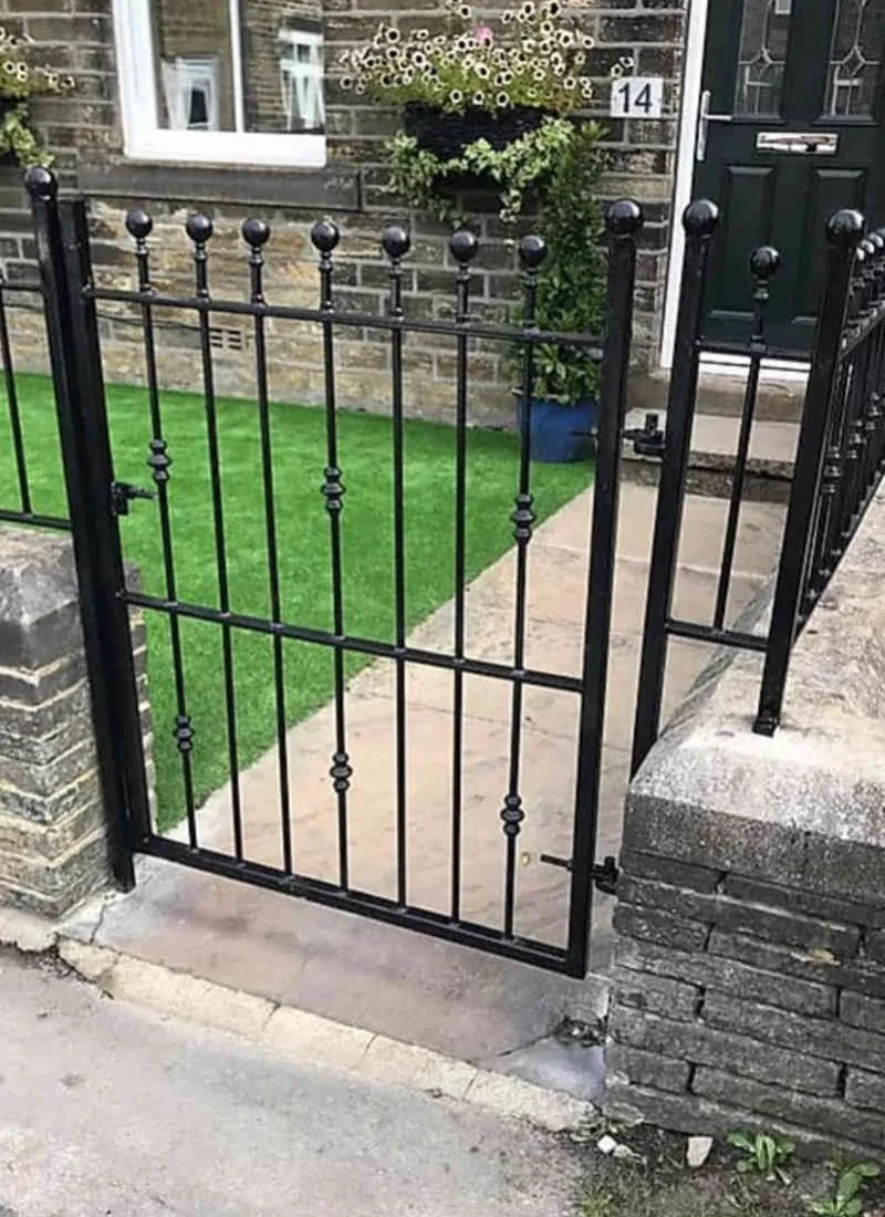 Black steel garden gate with matching railings