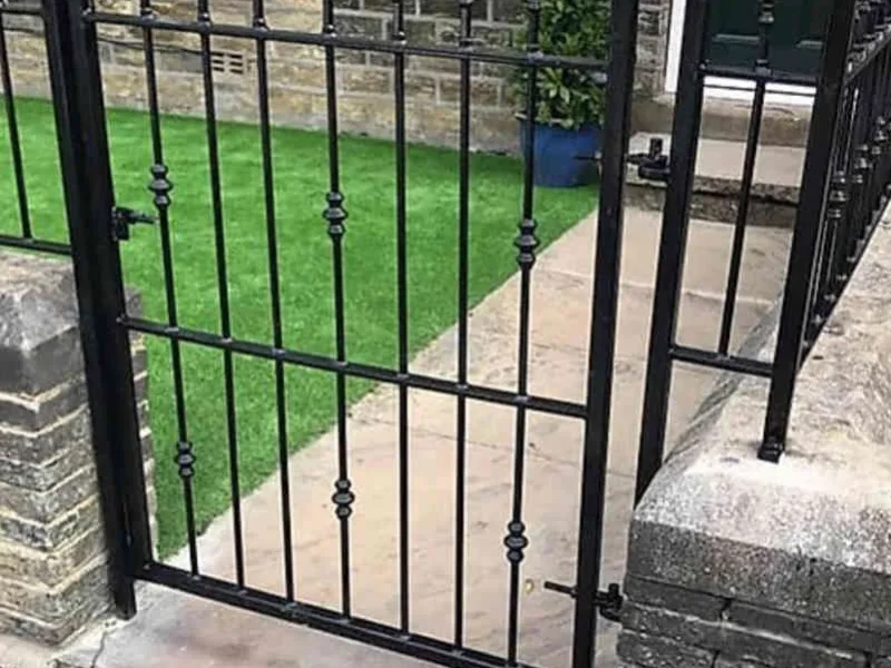 Black steel garden gate with matching railings