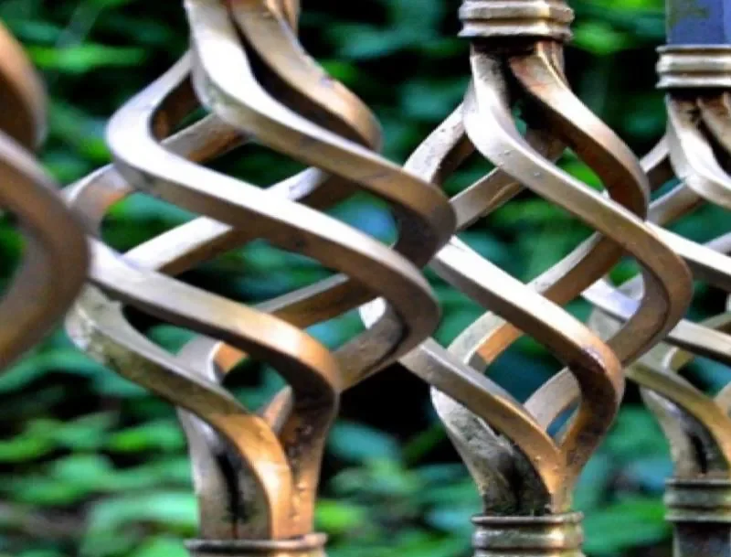 Close detail of decorative scrolled steel balustrade panels
