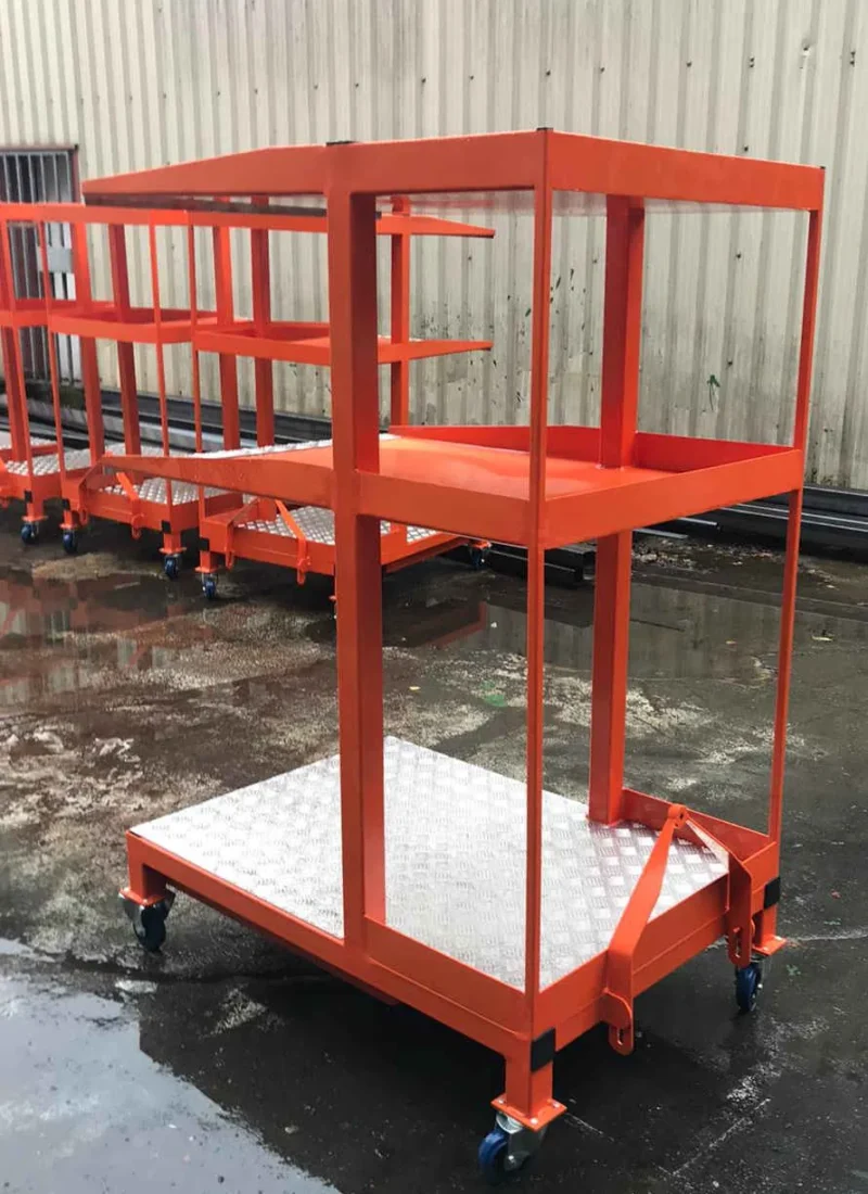 Orange fabricated industrial trolley with mesh shelves