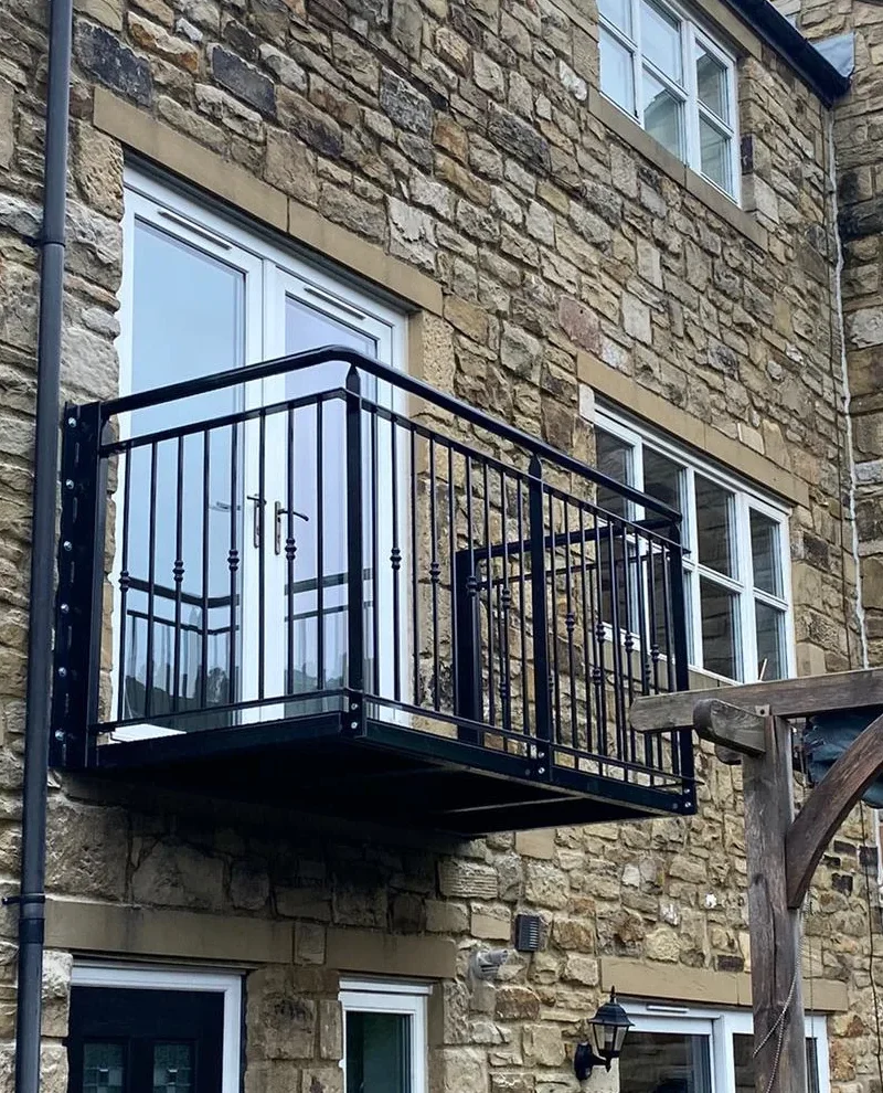 Hand-made steel Juliet balcony fitted to a stone building