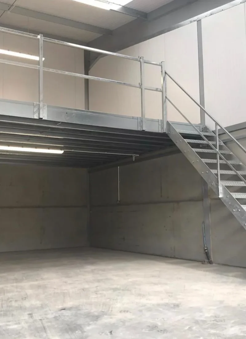 Steel mezzanine access staircase and landing in a warehouse unit